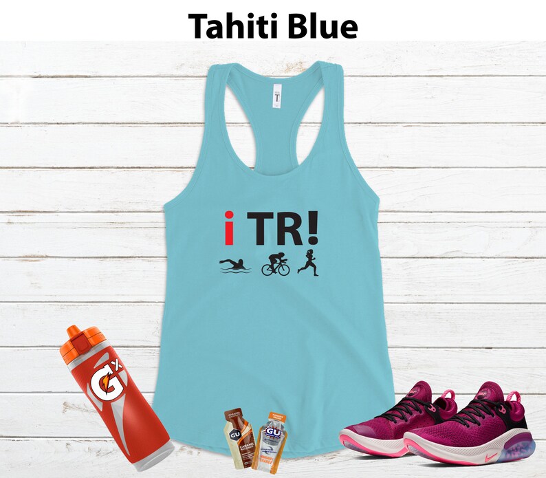 May include: Tahiti blue racerback tank top with "i TR!" text and triathlon icons. Includes a Gatorade bottle, two GU energy gel packets, and a pair of magenta running shoes.