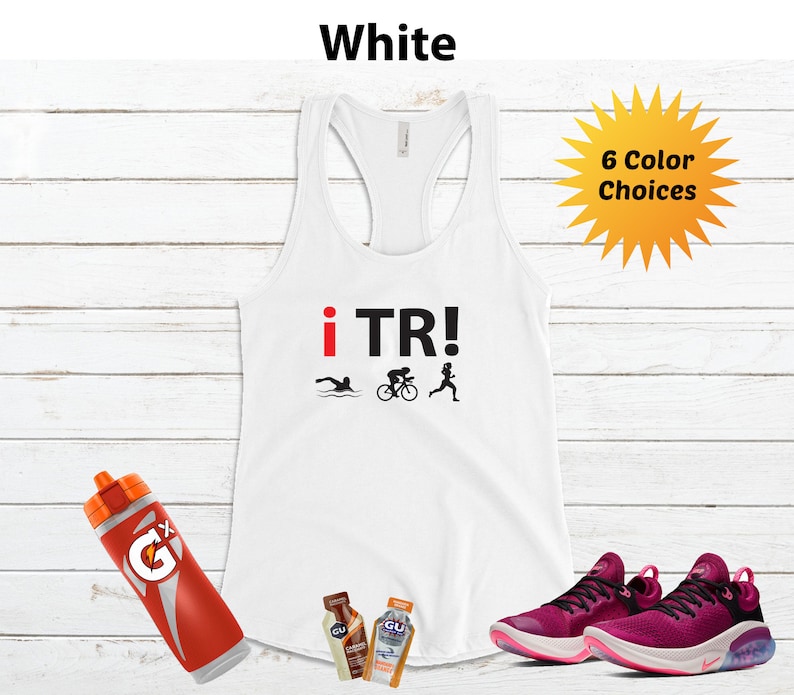 May include: White racerback tank top with "i TR!" text and triathlon symbols. Includes a red and orange water bottle, two energy gel packets, and a pair of magenta running shoes. The image also shows a yellow burst with "6 Color Choices" text.