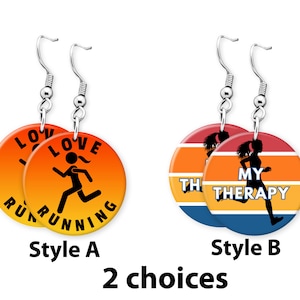 May include: Two pairs of earrings with a running theme. The first pair features a sunset gradient background with the text "I Love Running" and a silhouette of a runner. The second pair features a sunset gradient background with the text "My Therapy" and a silhouette of a runner.