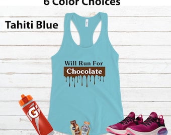 May include: A light blue tank top with the text "Will Run For Chocolate" in brown letters with chocolate dripping down. The tank top is on a wood background with a water bottle, energy gels, and running shoes.