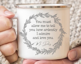 May include: White enamel mug with a black floral wreath and the text "You must allow me to tell you how ardently I admire and love you. M. Darcy"