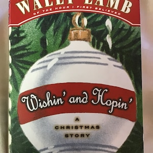 May include: A book cover with a red and white ornament on a green background. The title of the book is "Wishin' and Hopin'" and it is described as "A Christmas Story". The author is Wally Lamb, a New York Times bestselling author.