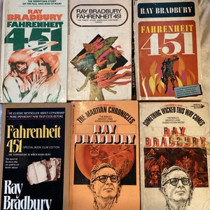 May include: A collection of six paperback books by Ray Bradbury. The books are all different colors and have different covers. The titles of the books are "Fahrenheit 451", "Fahrenheit 451", "Fahrenheit 451", "The Martian Chronicles", "Something Wicked This Way Comes", and "Fahrenheit 451".