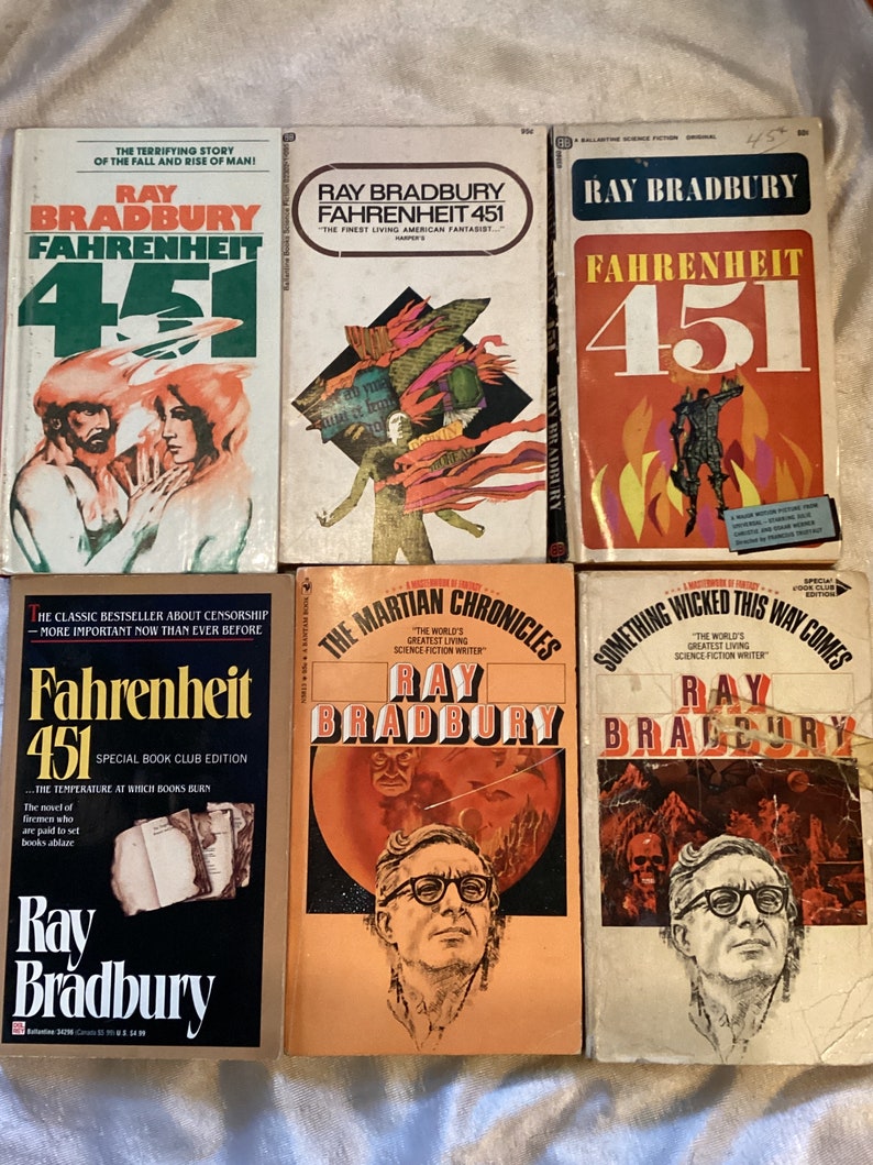 May include: A collection of six paperback books by Ray Bradbury. The books are all different colors and have different covers. The titles of the books are "Fahrenheit 451", "Fahrenheit 451", "Fahrenheit 451", "The Martian Chronicles", "Something Wicked This Way Comes", and "Fahrenheit 451".