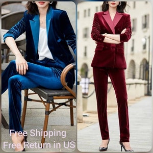May include: Two velvet suits. One is a deep blue with a contrasting teal lapel and matching pants. The other is a burgundy suit with a contrasting pink lapel and matching pants. Both suits have a double-breasted blazer.