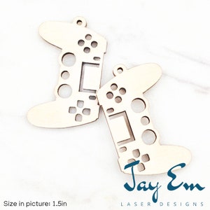 May include: Two unfinished wooden laser cut game controller ornaments. The ornaments are 1.5 inches in size and feature a detailed design of a game controller with buttons and a directional pad. The ornaments are perfect for crafting and decorating.
