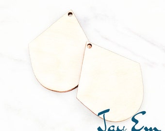 May include: Two unfinished wooden teardrop-shaped ornaments with a hole at the top, measuring 1.0 inches in the image.  The ornaments are on a white marble surface.  The text "Jay Em Laser Designs" is at the bottom of the image.