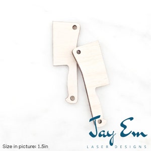 May include: Two unfinished wooden cut-out shapes of butcher knives, each with a hole at the top for hanging. The knives are 1.5 inches in size. The image is from Jay Em Laser Designs.