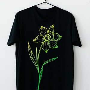May include: A black t-shirt featuring a green and yellow outline of a daffodil flower.