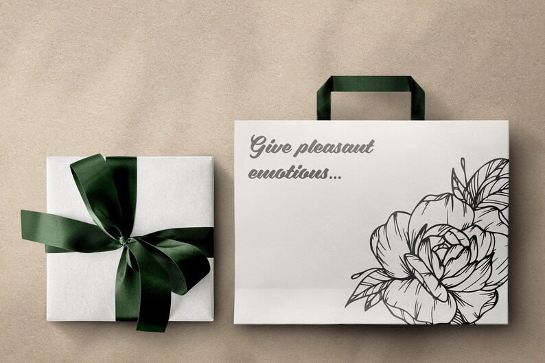 May include: A white gift bag with a black and white floral design and the text "Give pleasant emotions..." printed on the front. The bag has a green ribbon handle.