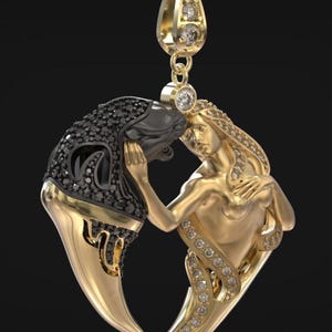 May include: A gold pendant necklace with a stylized design of two figures embracing. One figure is gold, the other is black with black gemstones. The pendant is suspended from a gold chain with diamond accents.