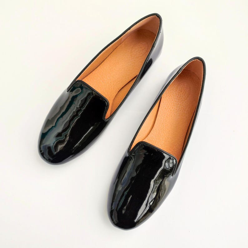 "Rounded-toe black loafers for women, designed for style-conscious professionals who value comfort for office wear or traveling."