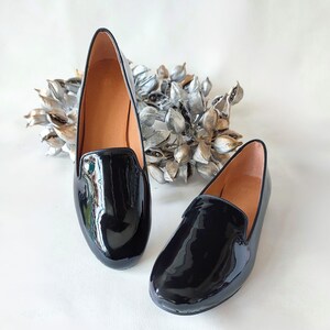 "Comfortable glossy black leather loafers for women, perfect for daily wear in spring, fall, or winter, offering both elegance and durability."