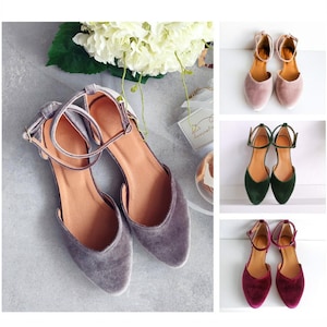 May include: Three pairs of velvet shoes with ankle straps in different colours: grey, green, and burgundy.