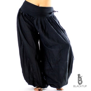 May include: Black harem pants with a wide waistband and a drawstring closure. The pants are made of a soft, flowing fabric and have a relaxed fit.