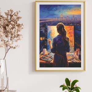 May include: A framed wall art print featuring an oil painting of a person standing with their back to the viewer, painting a vibrant canvas on an easel. The scene depicts a city skyline at dusk with warm orange and cool blue tones throughout.