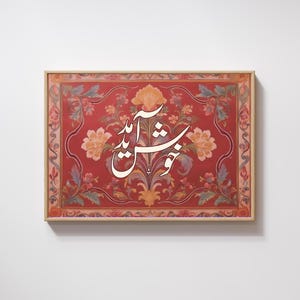 May include: A framed artwork featuring a red background with floral patterns in shades of orange, pink, and green. The artwork has white calligraphy in the center. The frame is a light brown color.