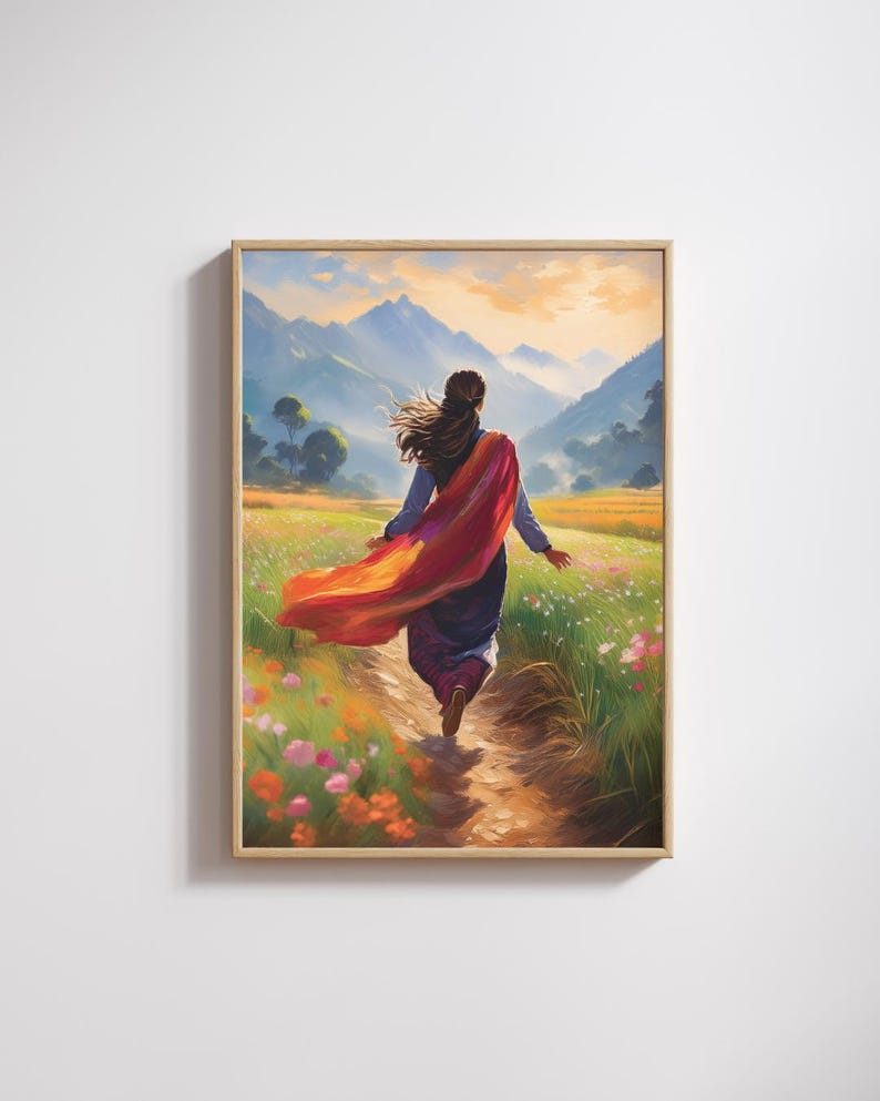 May include: A framed art print showing a person walking through a wildflower meadow towards mountains. The person wears a long, flowing red scarf. The artwork has a warm colour palette, with a sense of movement.