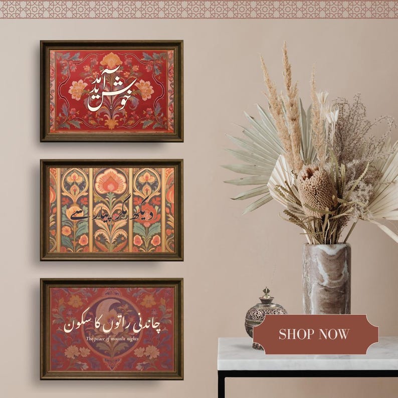 May include: Three framed art prints with ornate floral designs and calligraphy in a warm color palette. The top print has a red background, the middle one has a multi-colored design, and the bottom one has a red background. A vase of dried flowers sits to the right.