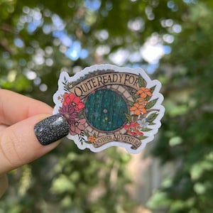 May include: A white sticker with a green door, flowers, and the text "Quite Ready For Another Adventure".