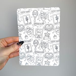 May include: A rectangular white sticker sheet featuring a repeating black line art pattern of fantasy-themed icons including swords, crowns, hearts, mirrors, and beds, with text labels such as Fantasy Reader, Secret Heir, and Enemies to Lovers.