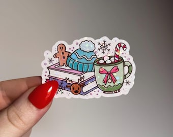 May include: A colorful sticker featuring winter-themed illustrations. It includes a gingerbread man, a blue beanie, a mug of hot chocolate with marshmallows and a candy cane, a stack of books, a reindeer, and snowflakes.