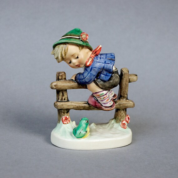 hummel boy on fence with frog
