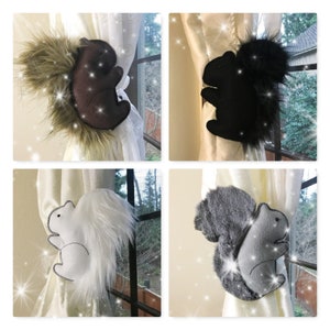 May include: Four different colored squirrel curtain tie backs. The squirrels are made of felt and have a fluffy tail. The tie backs are shown on white curtains.