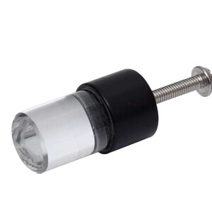 May include: A cylindrical cabinet knob featuring a clear, faceted acrylic front section attached to a solid matte black base. A silver-toned metal screw with a flat head extends from the back of the knob for installation purposes.