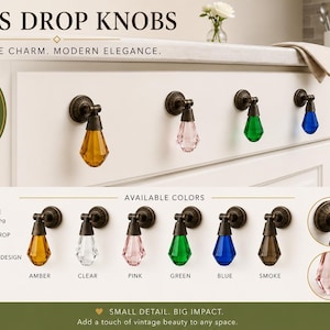 May include: Glass drop knobs featuring faceted teardrop-shaped glass in amber, clear, pink, green, blue, and smoke colors. Each knob has a dark metal base with an adjustable pivot mechanism. The text reads GLASS DROP KNOBS and AVAILABLE COLORS.