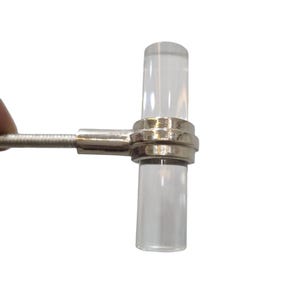 Puede incluir: Un pomo de armario de vidrio transparente con una base de metal plateado y un tornillo.