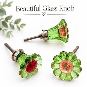 May include: Three flower-shaped glass knobs with green petals and a central red or peach-coloured faceted glass accent. Each knob features a silver-toned metal base and a threaded bolt. The text "Beautiful Glass Knob" is visible at the top.