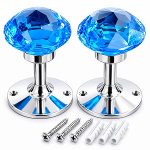 May include: Two bright blue faceted crystal knobs with polished chrome bases. Each knob features a round, multi-faceted top and a circular mounting plate with two screw holes. Three silver metal screws and three white plastic wall anchors are included.