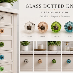 May include: Glass dotted knobs with a fire polish finish, available in clear, peach, green, blue, and lime colors. Each knob features a textured, spherical glass surface attached to a dark metal base, shown installed on drawers and individually.