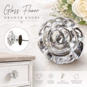 May include: A flower-shaped drawer knob made of clear glass with a metallic silver finish. The knob features a layered petal design and includes a dark metal base with a mounting screw. Text on the image reads Glass Flower DRAWER KNOBS.