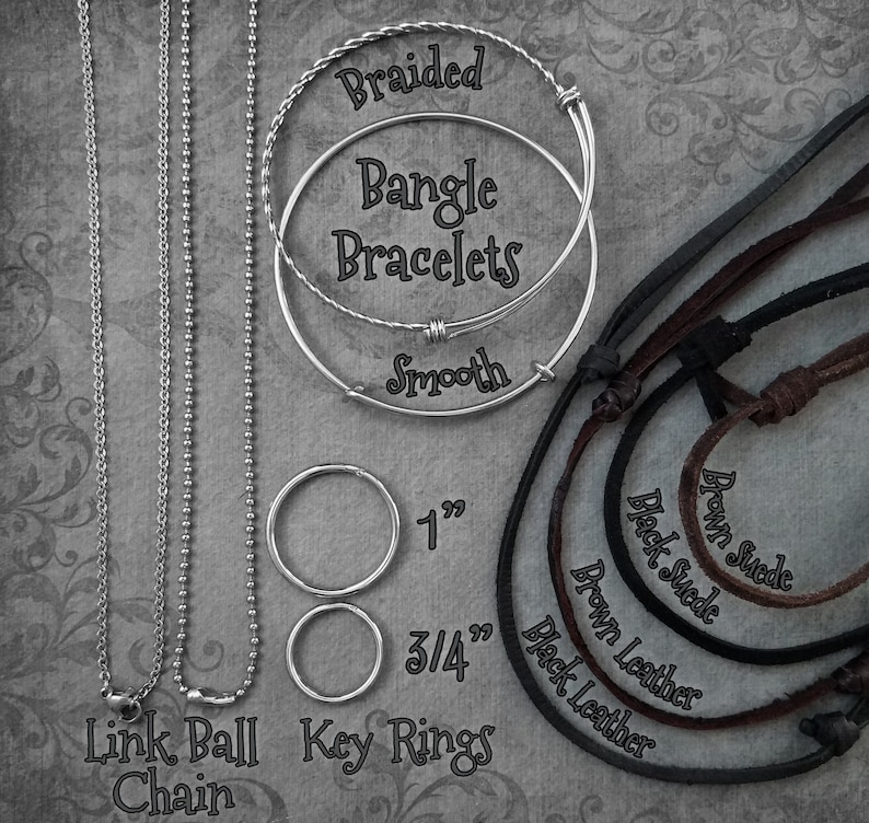 May include: A variety of silver chains, key rings, and leather cords. The chains include a link ball chain and a smooth chain. The key rings are 1 inch and 3/4 inch in diameter. The leather cords are brown suede, black suede, brown leather, and black leather.