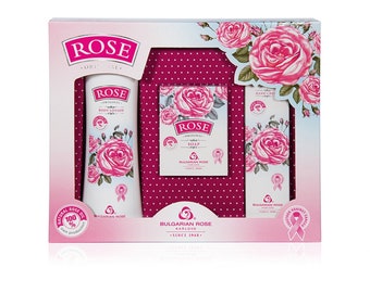 May include: A gift set featuring Bulgarian Rose products. The set includes a body lotion, soap, and hand cream, all adorned with pink rose illustrations. The packaging is white and pink, with the brand name "ROSE" prominently displayed.