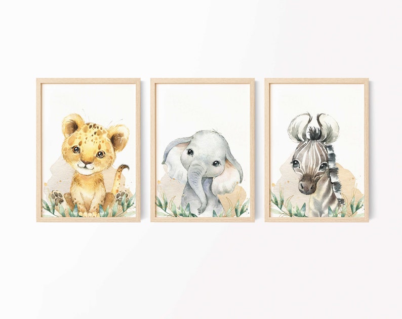 May include: Three framed watercolor illustrations of jungle animals. A lion cub, an elephant calf, and a zebra foal are depicted in a whimsical style with green foliage.