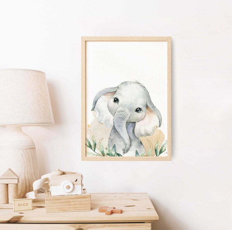 May include: A watercolor painting of a cute baby elephant with big ears and large eyes. The elephant is surrounded by green leaves and a light brown background.