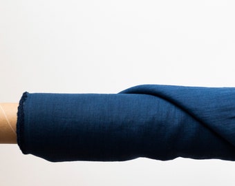 May include: A roll of dark blue linen fabric on a cardboard tube.