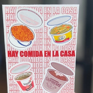 May include: A white sticker sheet with red text that reads "Hay Comida En La Casa" repeated multiple times. The sticker sheet features three different food containers with lids: a red container with orange food, a green container with green food, and a brown container with brown food. The containers are labeled with the brands "Yoplait", "Country Crock", and "Butter!"
