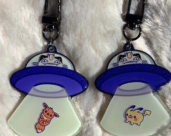 pkmn alien abduction keychain, pkachu and evee- glow in the dark acrylic
