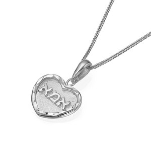 Puede incluir: Un collar con colgante en forma de coraz&oacute;n de tono plateado con un borde texturizado y la palabra hebrea "Ahava" en relieve sobre un centro mate. El colgante cuelga de una delicada cadena de tono plateado con acabado pulido y una reasa.