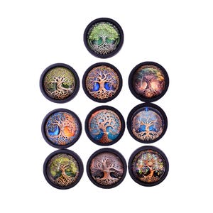 May include: Twelve round, black-framed glass cabochons with colorful images of a tree of life design.
