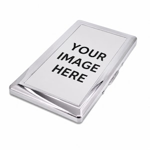 May include: A rectangular silver-toned metal business card holder with a polished, reflective finish. The center features a smooth, flat white panel with the black printed text "YOUR IMAGE HERE" centered on the surface of the case.