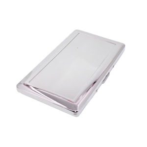 May include: A rectangular, silver-colored business card holder. The case has a shiny, reflective surface and a hinged closure. The edges are slightly beveled, adding a touch of elegance to the design. The overall aesthetic is sleek and modern.