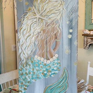 Painting on old recycle wood fence! This Queen of the sea is looking for a home she has a wonderful beach blue tail with glitter!!