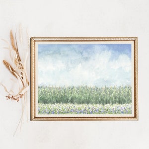 May include: A watercolor painting of a field of corn with purple wildflowers in the foreground. The sky is a light blue with white clouds.