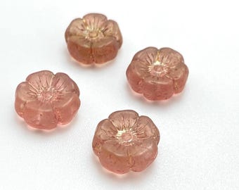 Four peach pink Czech hibiscus flower beads with gold lustre centres displayed on a plain white background.
