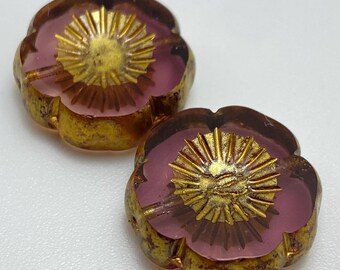 Two amethyst purple Czech table cut hibiscus flower beads with gold wash, shown from above on a plain white background.